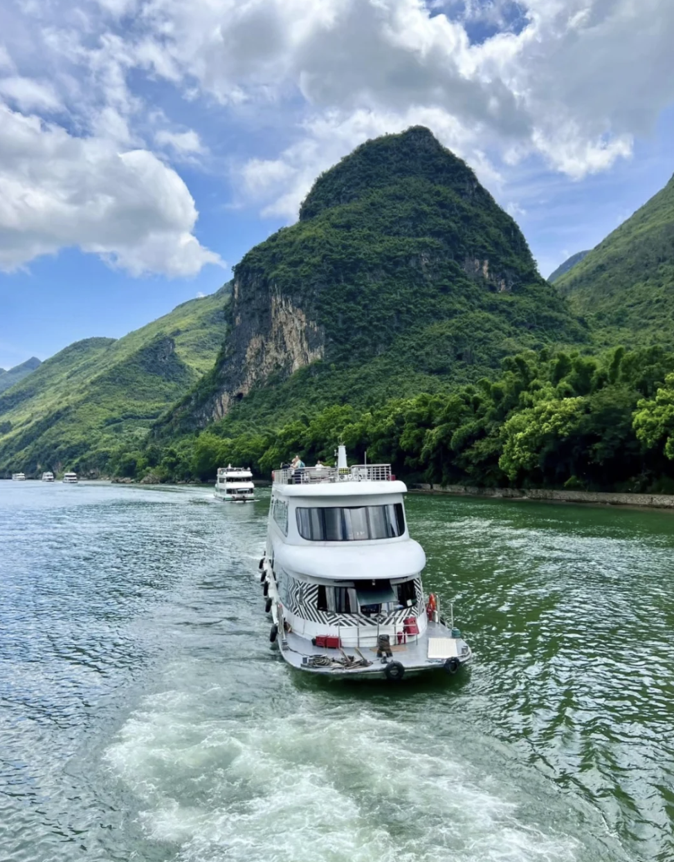 River cruise boat with karst mountains
